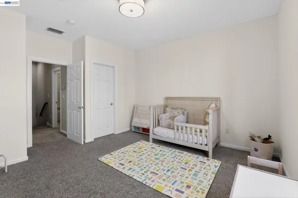 a room with a baby crib and a couch