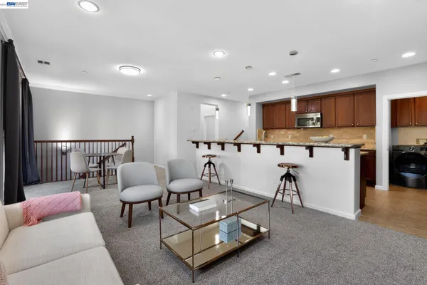 a living room with furniture kitchen view and a view
