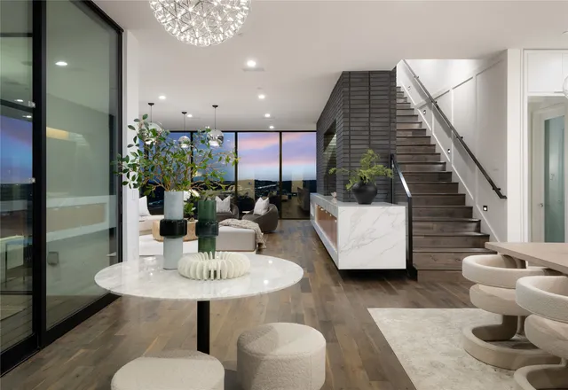 a dining room with furniture and a floor to ceiling window