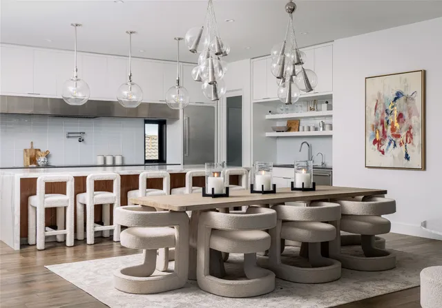 a kitchen with kitchen island a counter top space a sink and cabinets