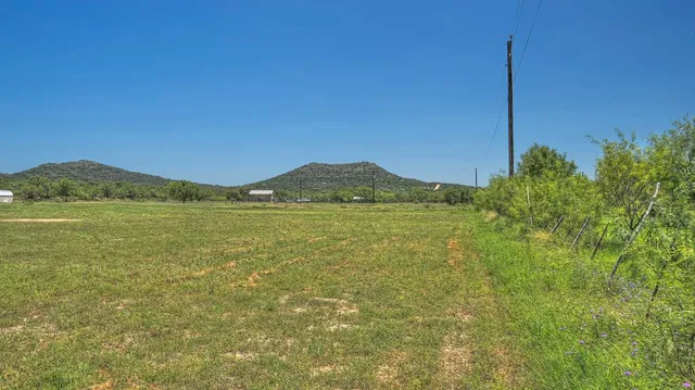 a view of a field with an ocean view