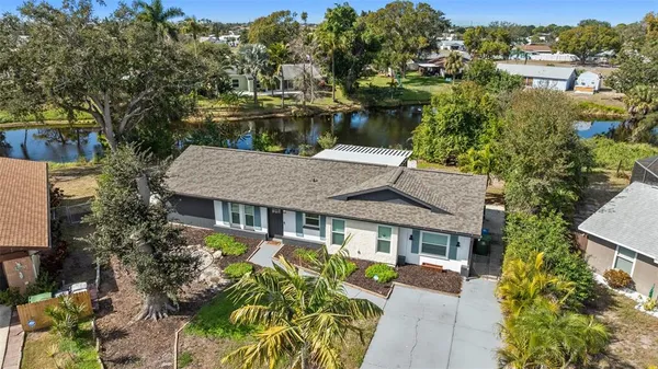 a aerial view of a house with a yard table and chairs