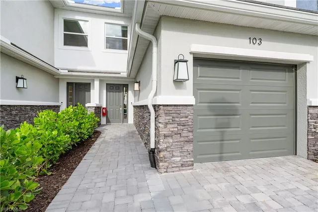 a large white kitchen with stainless steel appliances kitchen island granite countertop lots of counter top space