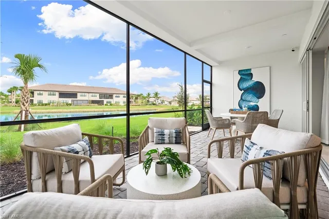 a view of a chairs and table in patio with a lake view