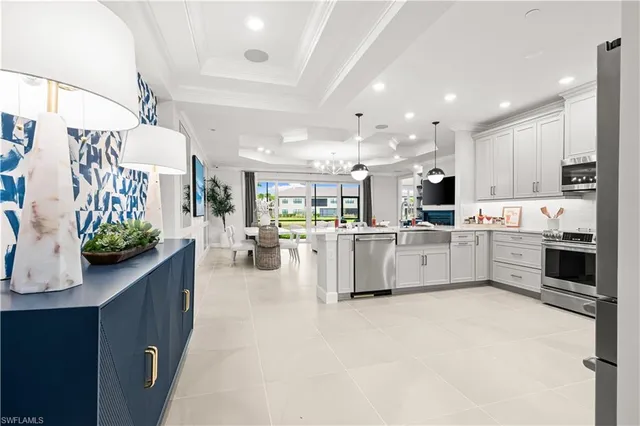 a kitchen with stainless steel appliances kitchen island granite countertop a sink and a stove