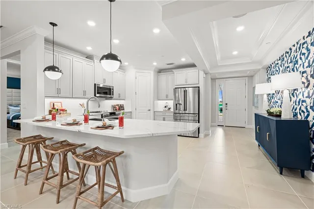 a large kitchen with a refrigerator and a stove top oven