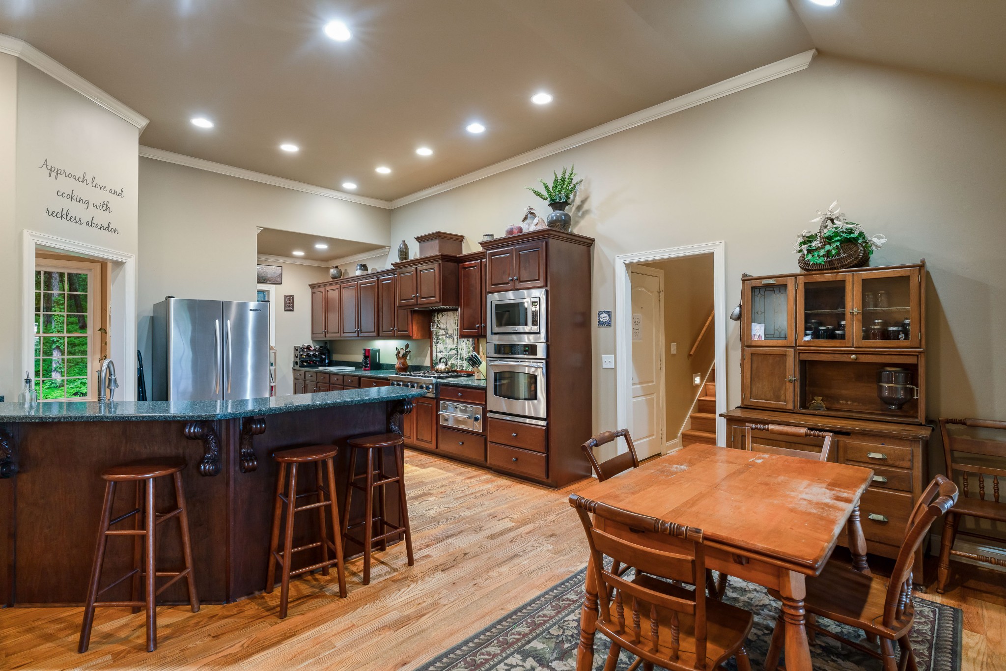1976 Cooks Road Mount Juliet, TN 37122 - Photo 32 of 70 a kitchen with stainless steel appliances kitchen island granite countertop a table chairs and a refrigerator