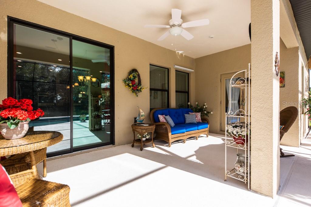 15437 Mulholland Road Parrish, FL 34219 - Photo 38 of 47 Covered area of the 18' x 10' Screened Lanai and pool cage where grilling and eating can easily be done!