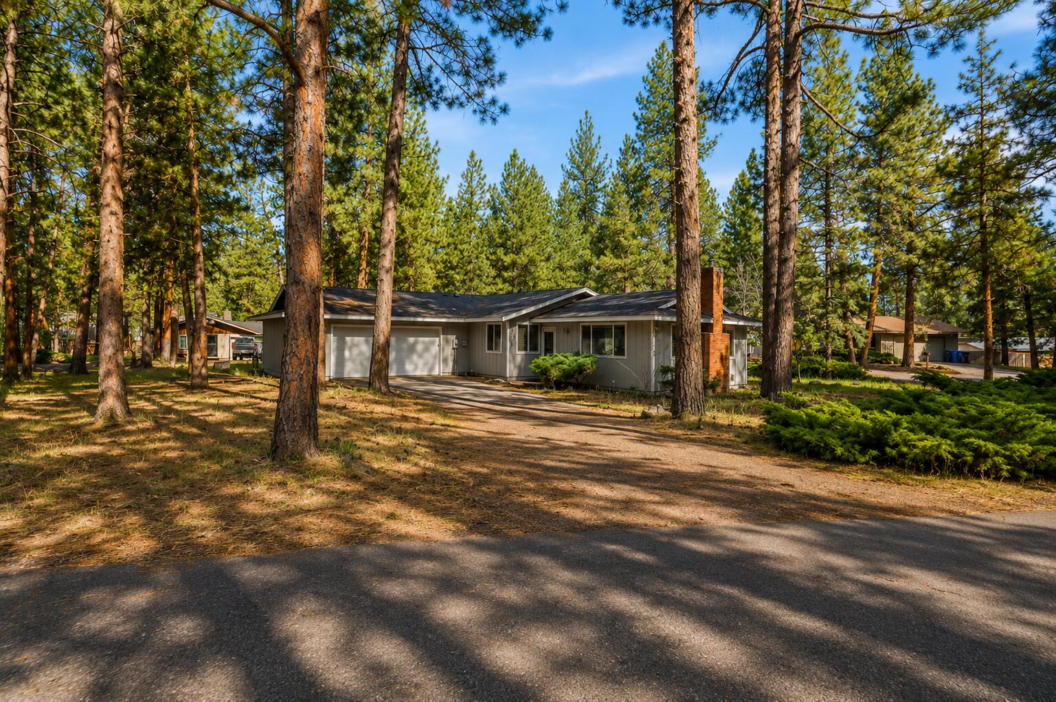 19968 Double Tree Court Bend, OR 97702 - Photo 1 of 28 a front view of a house with a tree in a yard