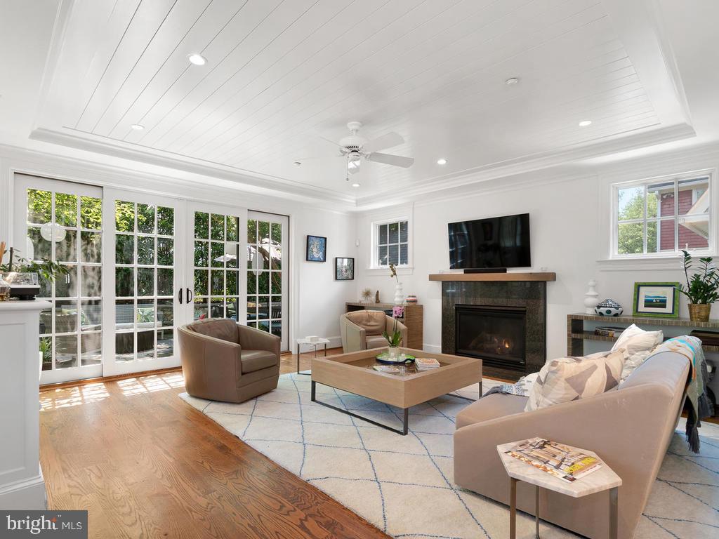 4400 Elm Street Chevy Chase, MD 20815 - Photo 13 of 61 a living room with furniture a fireplace and a flat screen tv