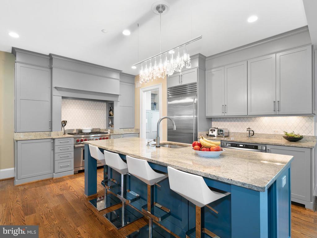 4400 Elm Street Chevy Chase, MD 20815 - Photo 18 of 61 a kitchen with a dining table chairs and stove top oven