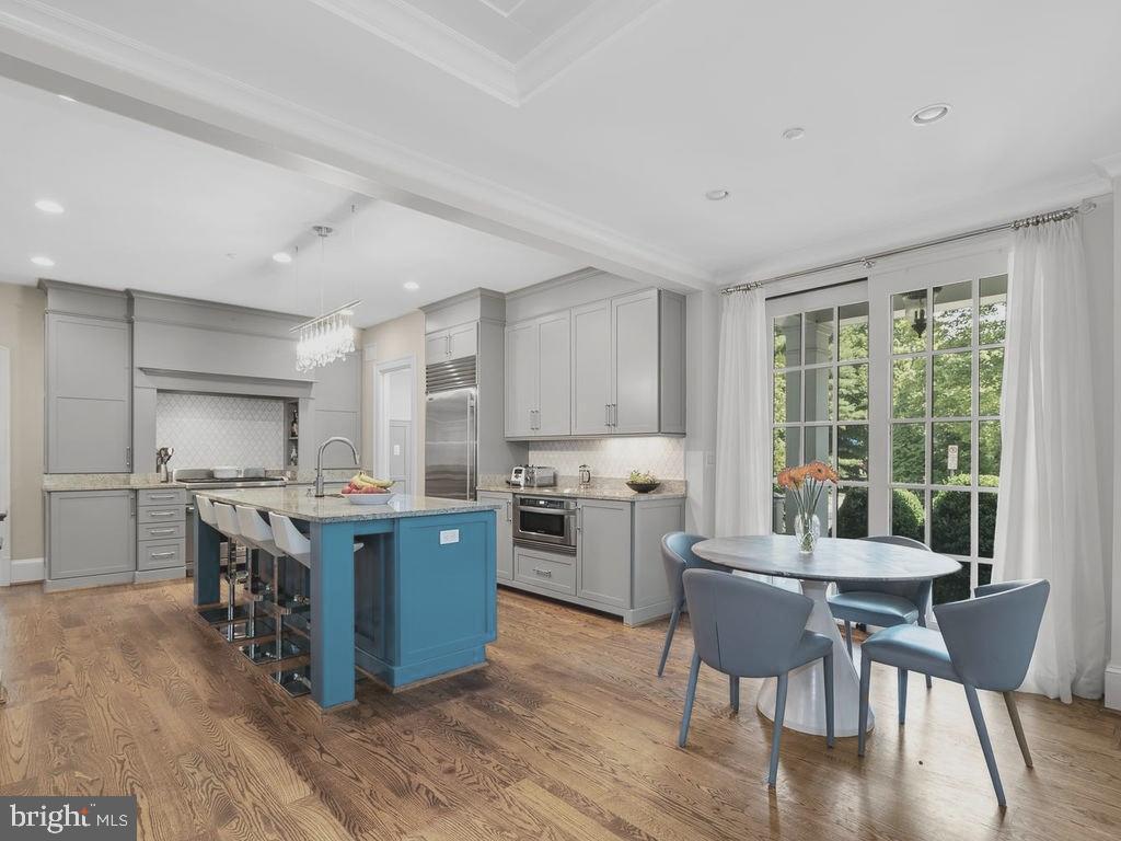 4400 Elm Street Chevy Chase, MD 20815 - Photo 19 of 61 a kitchen with a stove a refrigerator and dining table