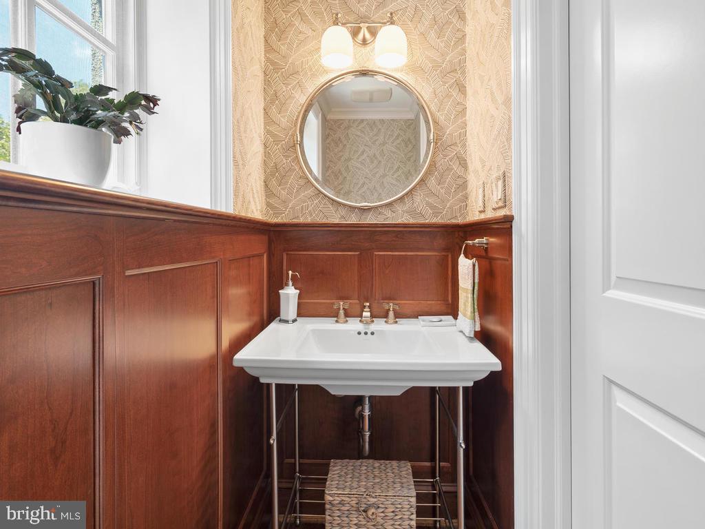 4400 Elm Street Chevy Chase, MD 20815 - Photo 30 of 61 a bathroom with a sink and a mirror