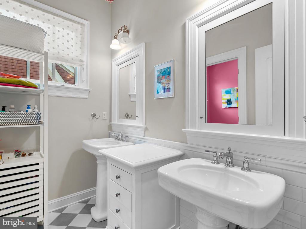 4400 Elm Street Chevy Chase, MD 20815 - Photo 31 of 61 a bathroom with a sink and a mirror