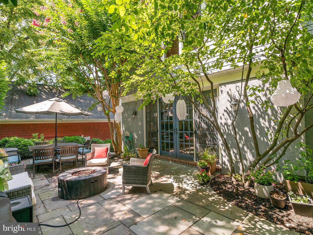 4400 Elm Street Chevy Chase, MD 20815 - Photo 48 of 61 a view of a patio with couches and table and chairs under an umbrella