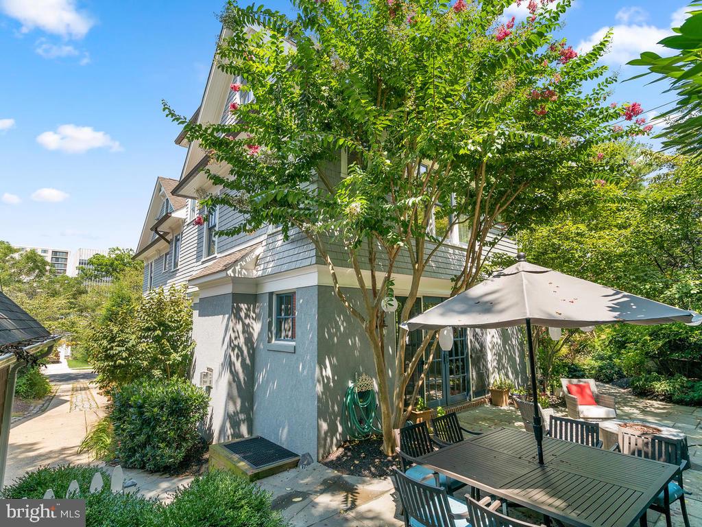 4400 Elm Street Chevy Chase, MD 20815 - Photo 50 of 61 a patio with a table and chairs under an umbrella
