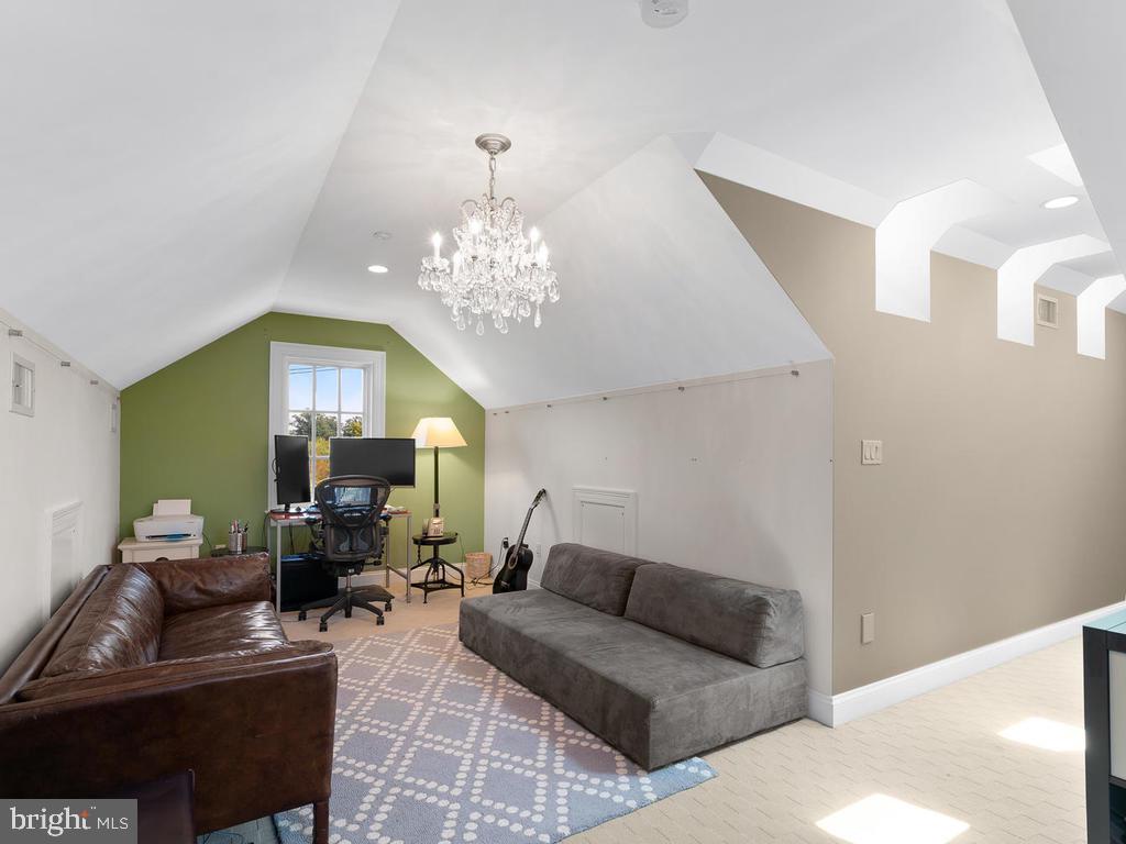 4400 Elm Street Chevy Chase, MD 20815 - Photo 54 of 61 a living room with furniture chandelier and a mirror