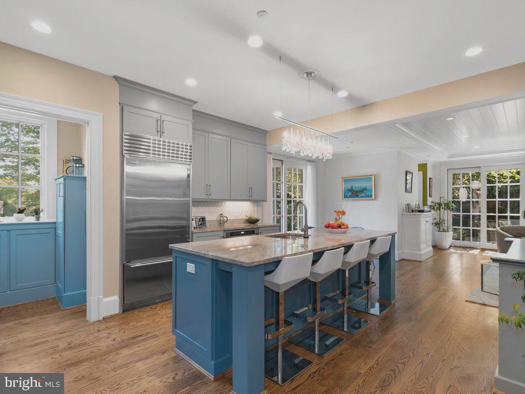 4400 Elm Street Chevy Chase, MD 20815 - Photo 9 of 61 a kitchen with stainless steel appliances granite countertop a table chairs sink refrigerator and cabinets