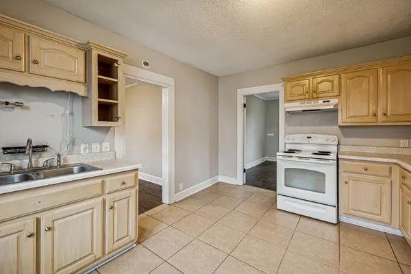a kitchen with stainless steel appliances granite countertop a sink and cabinets