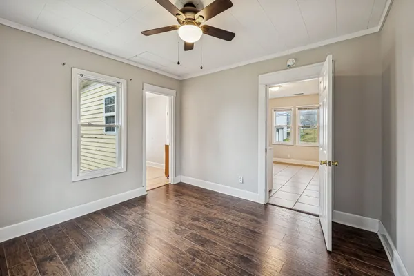wooden floor in an empty room with a window
