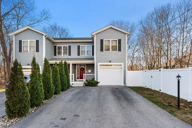 a view of staircase with lots of frames on wall and a potted plant
