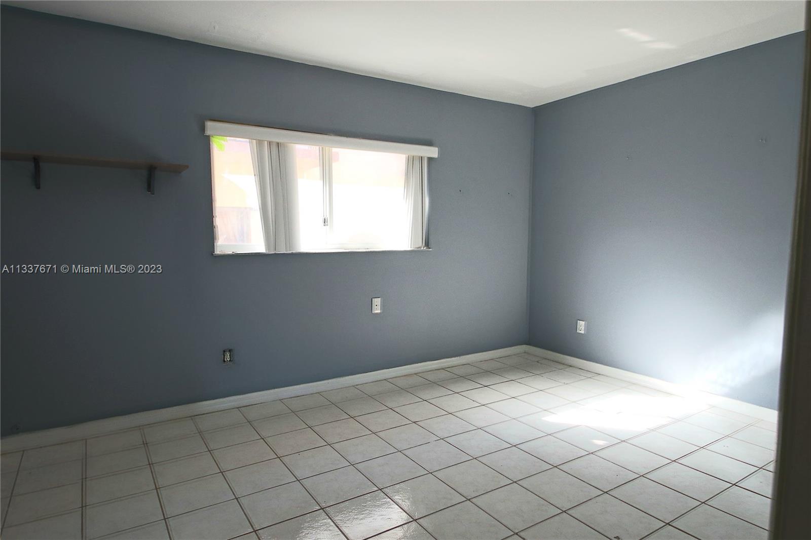655 West 68th Street, Unit 10 Hialeah, FL 33014 - Photo 13 of 19 a view of an empty room with a window