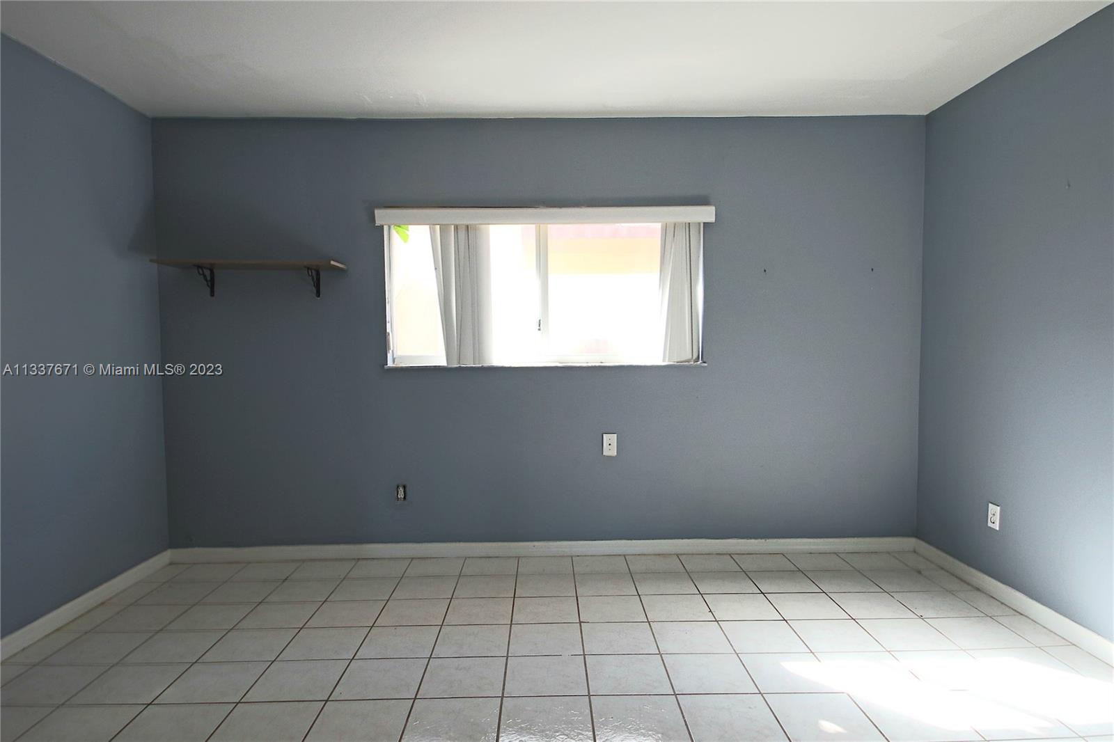 655 West 68th Street, Unit 10 Hialeah, FL 33014 - Photo 14 of 19 a view of an empty room and window