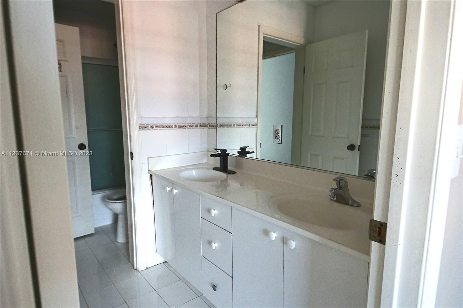 655 West 68th Street, Unit 10 Hialeah, FL 33014 - Photo 15 of 19 a bathroom with a sink and a mirror