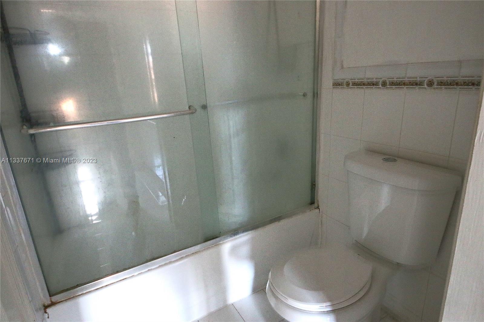 655 West 68th Street, Unit 10 Hialeah, FL 33014 - Photo 16 of 19 a white toilet sitting next to a shower