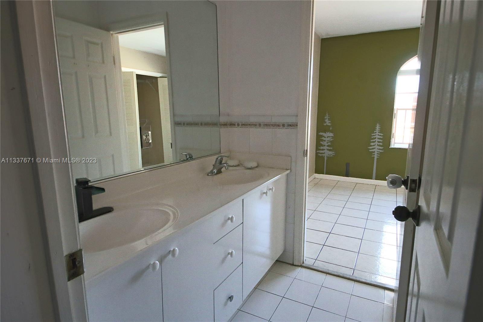 655 West 68th Street, Unit 10 Hialeah, FL 33014 - Photo 17 of 19 a bathroom with a sink and a mirror