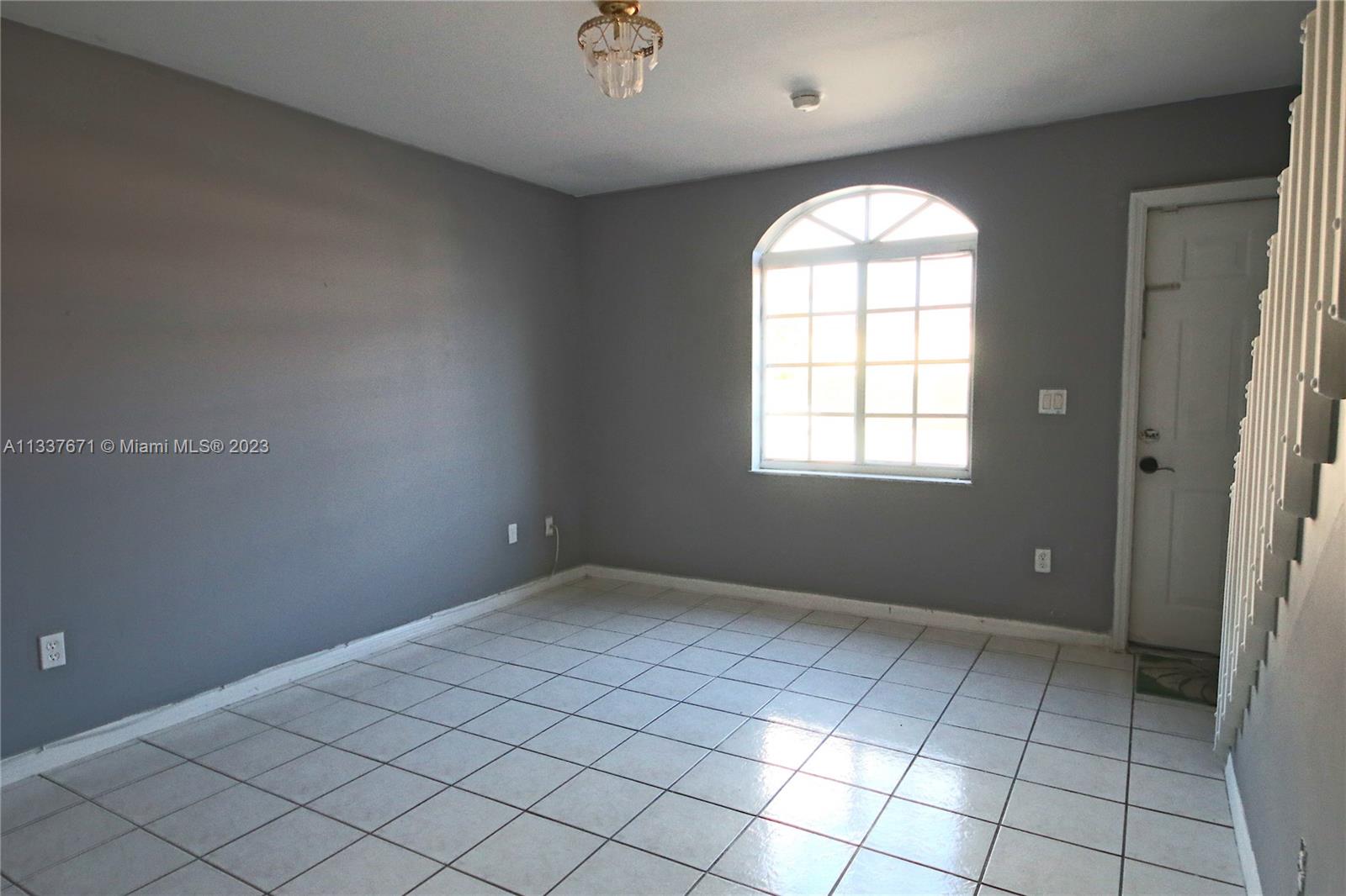 655 West 68th Street, Unit 10 Hialeah, FL 33014 - Photo 4 of 19 an empty room with windows