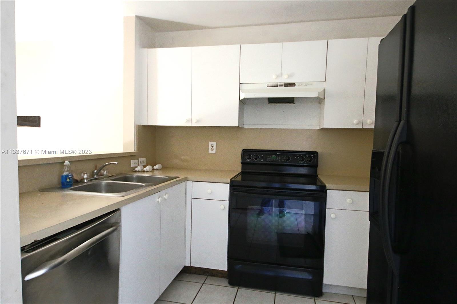 655 West 68th Street, Unit 10 Hialeah, FL 33014 - Photo 5 of 19 a kitchen with a sink and a stove