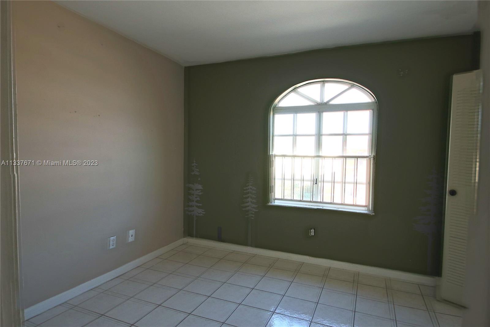 655 West 68th Street, Unit 10 Hialeah, FL 33014 - Photo 8 of 19 an empty room that has a window