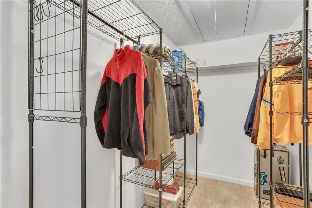 3445 Ivys Walk Atlanta, GA 30340 - Photo 15 of 21 a view of walk in closet with clothes and shoes