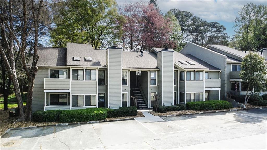 3445 Ivys Walk Atlanta, GA 30340 - Photo 18 of 21 a view of a white house with large windows and plants