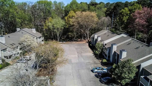 an aerial view of a house with a yard and trees