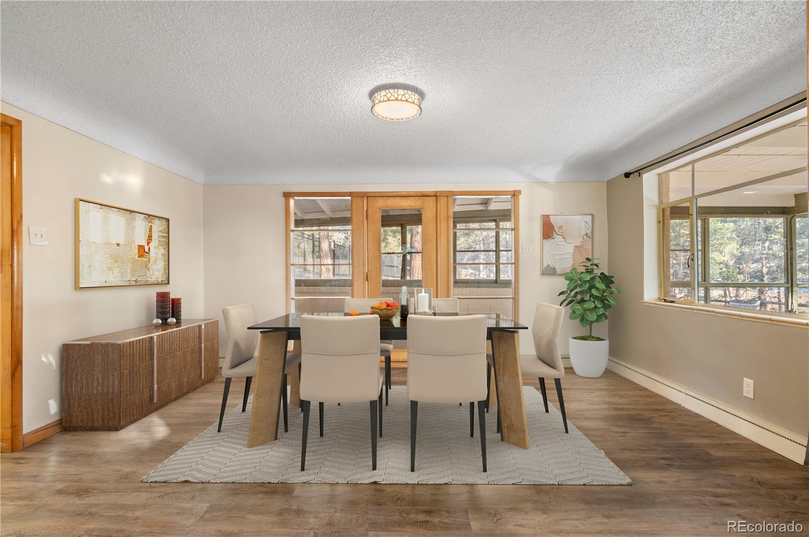 7076 Inspiration Drive Parker, CO 80138 - Photo 11 of 50 a view of a dining room with furniture window and wooden floor