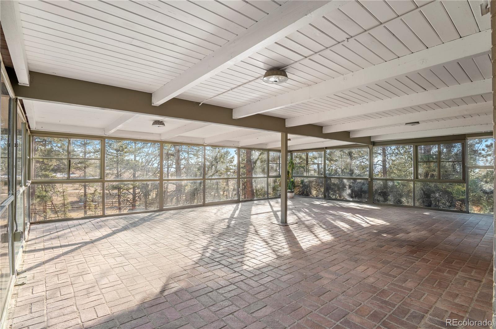 7076 Inspiration Drive Parker, CO 80138 - Photo 16 of 50 a view of an empty room with wooden floor and a window