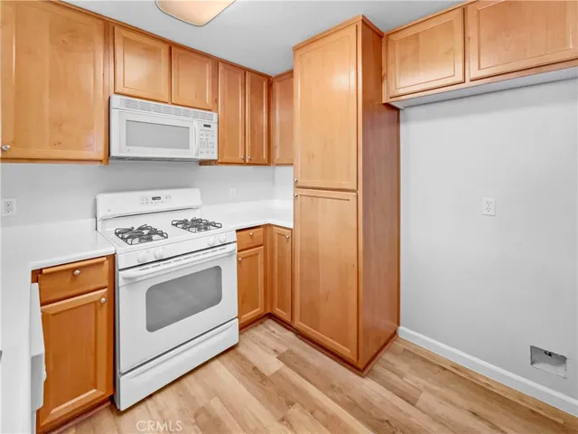 a view of a storage and utility room with washer and dryer