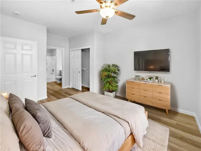 a bedroom with a bed and a flat screen tv