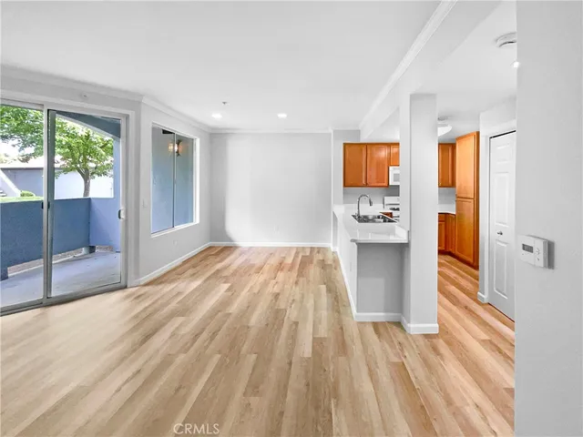 a room with a bed and wooden floor