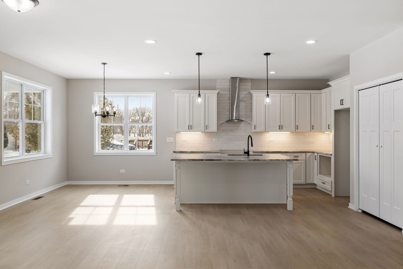 203 Hickory Street Peotone, IL 60468 - Photo 4 of 20 a kitchen with stainless steel appliances granite countertop a sink a window and white cabinets