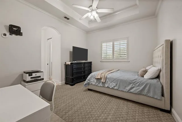 a bedroom with a bed dresser and a flat tv screen