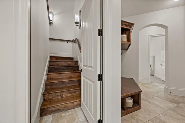 a view of a hallway with entryway wooden floor and front door
