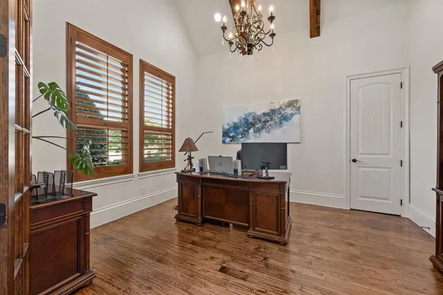 a living room with furniture a fireplace and a large window
