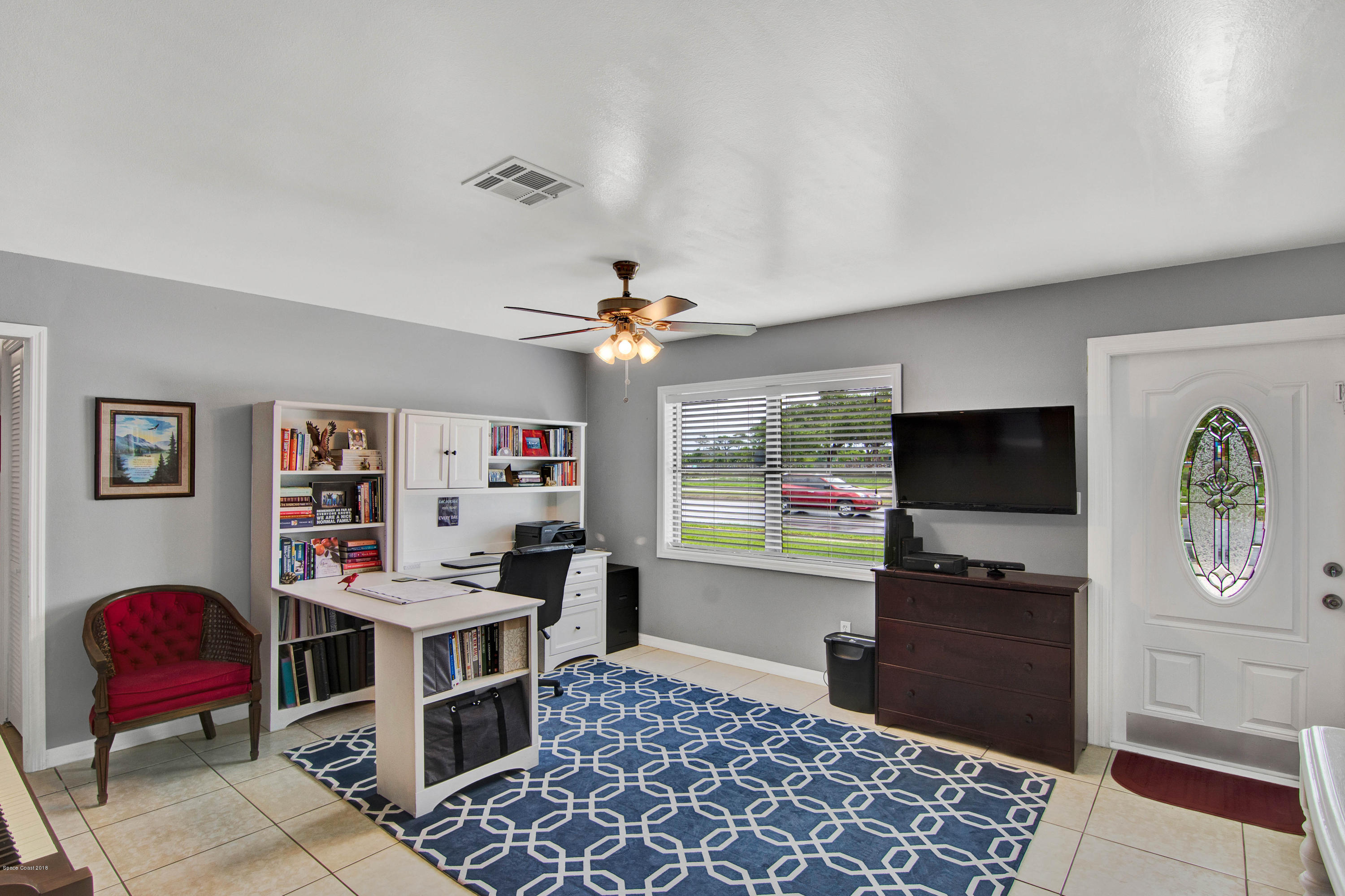 2512 Post Road Melbourne, FL 32935 - Photo 11 of 25 a living room with furniture and a flat screen tv