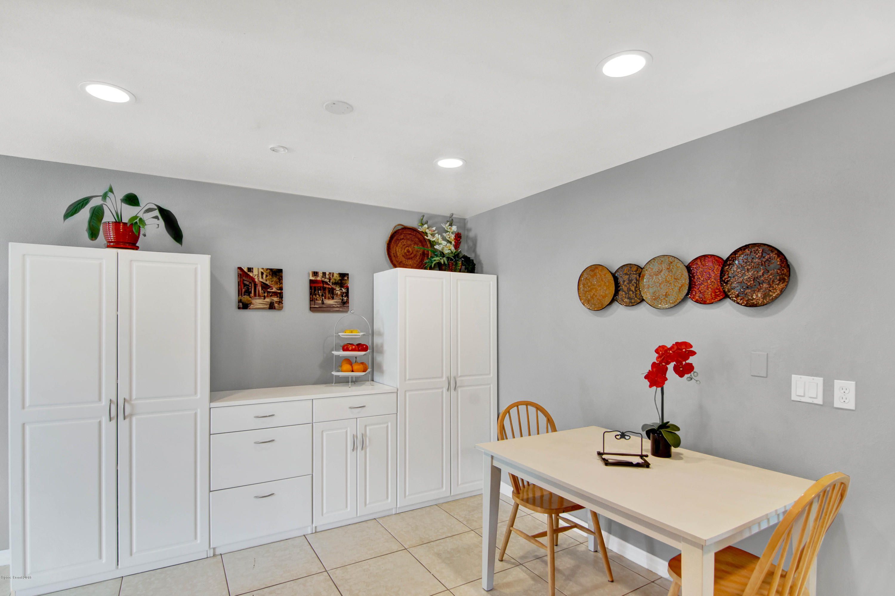 2512 Post Road Melbourne, FL 32935 - Photo 14 of 25 a living room with kitchen island a table and white walls