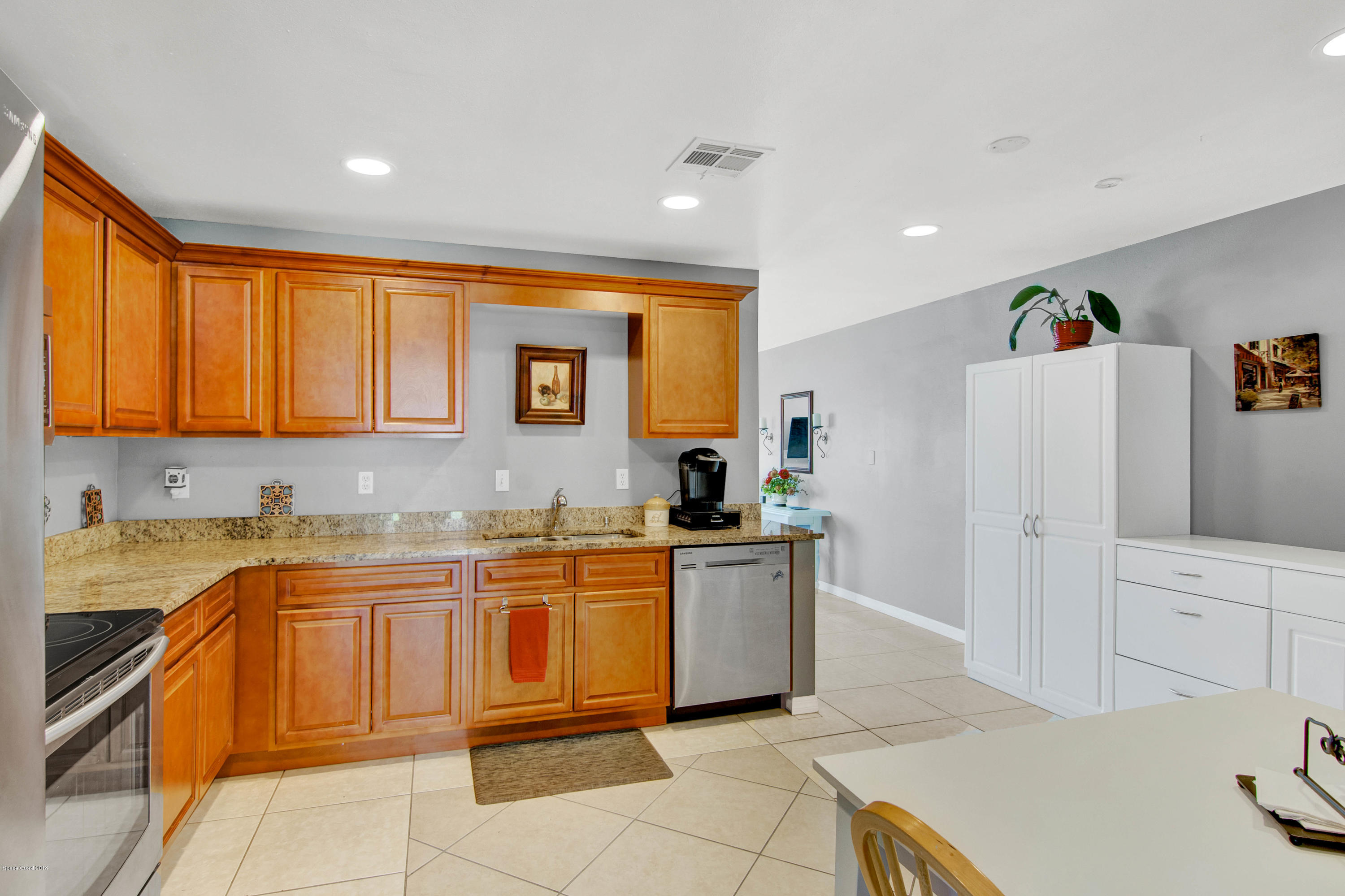 2512 Post Road Melbourne, FL 32935 - Photo 15 of 25 a kitchen with a sink a stove top oven and cabinetry