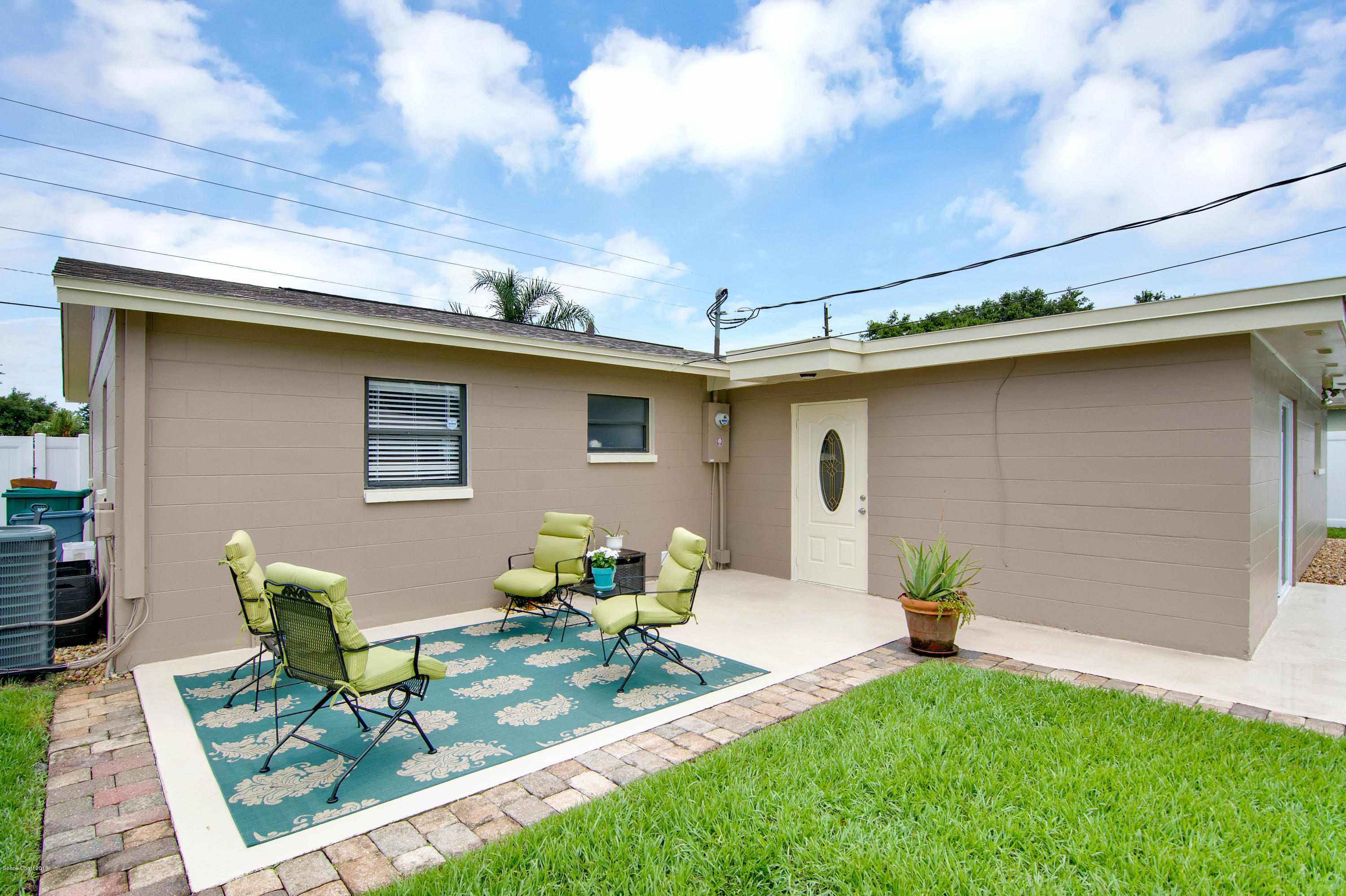 2512 Post Road Melbourne, FL 32935 - Photo 24 of 25 a front view of house with yard outdoor seating and barbeque oven