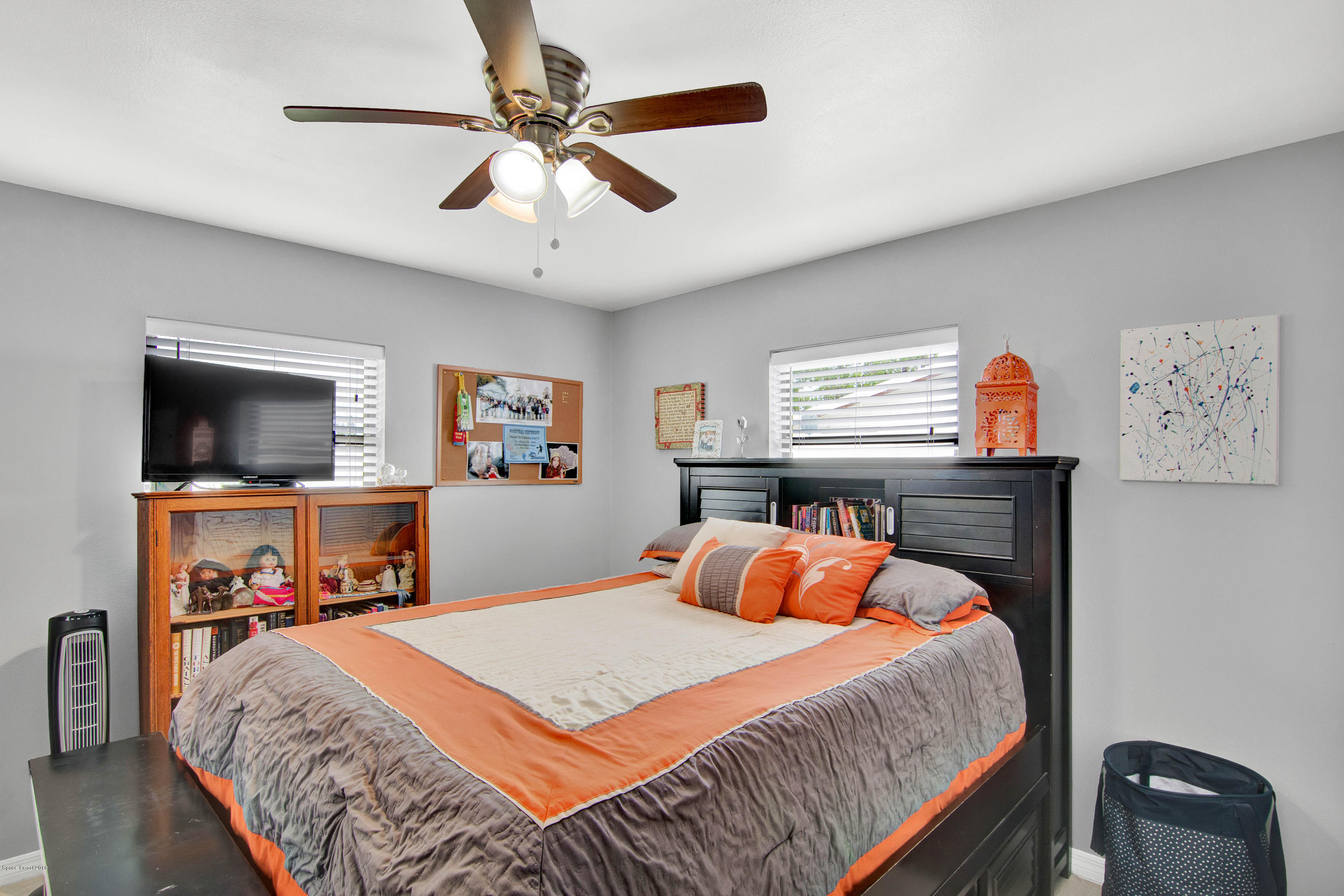 2512 Post Road Melbourne, FL 32935 - Photo 10 of 25 a bedroom with a bed and a flat screen tv